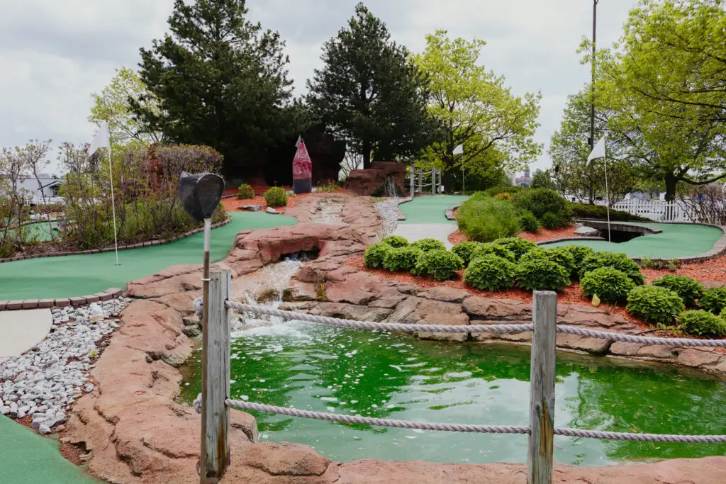 Mini golf course at Buoy 18 in Bay City, Michigan, featuring waterfalls, landscaped greens, and scenic obstacles.